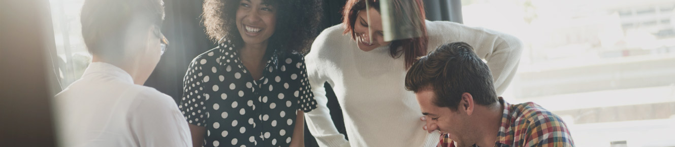 photo of individuals reviewing business and smiling 