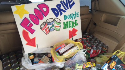 collection of canned food in back of trunk