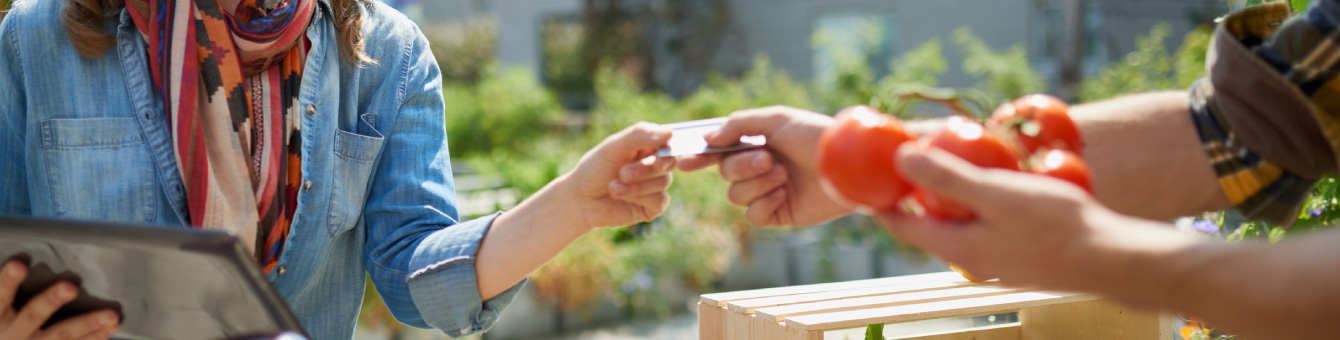 Making a purchase at the farmers market using a credit card