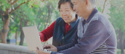 photo of older couple working on their laptop together