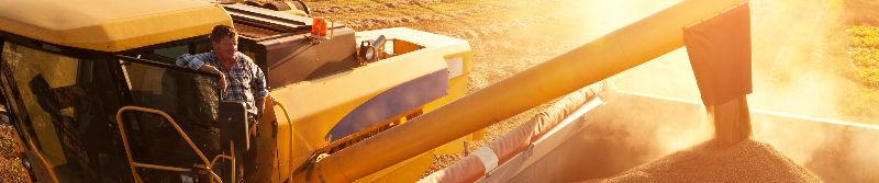 photo of a harvesting tractor depositing grain into a bin