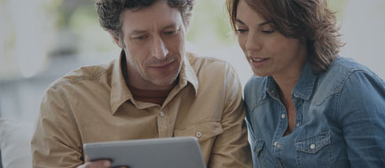 middle aged couple working on ipad together